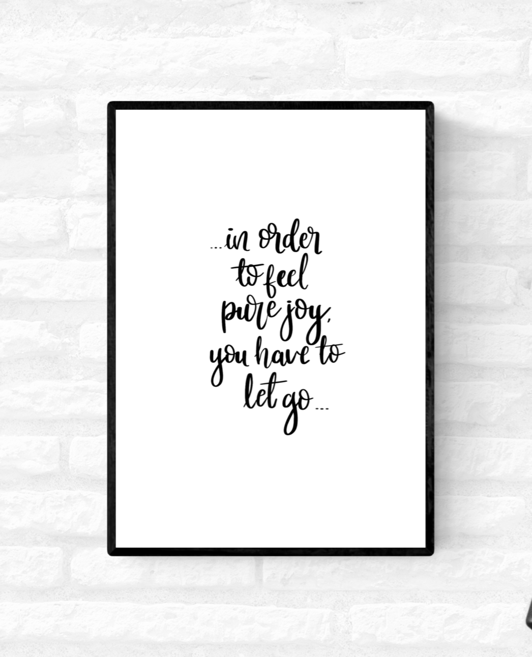 Framed wall quote print with the words, “in order to feel pure joy you have to let go”