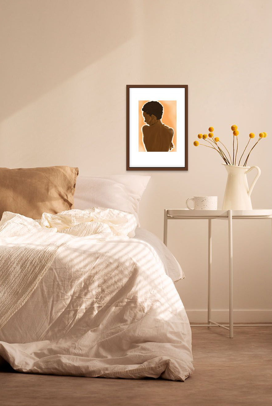 A bedroom wall with hung and framed sensual artwork of a black woman with natural hair’s nude back 