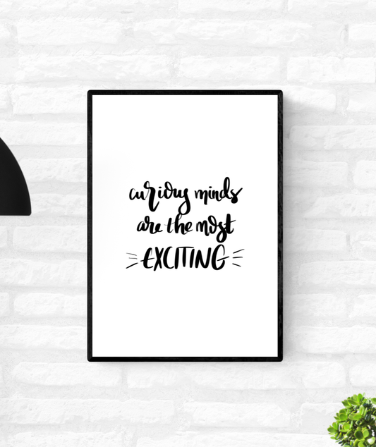 Wall quote print that is framed and mounted on a wall with the words, “curious minds are the most exciting”