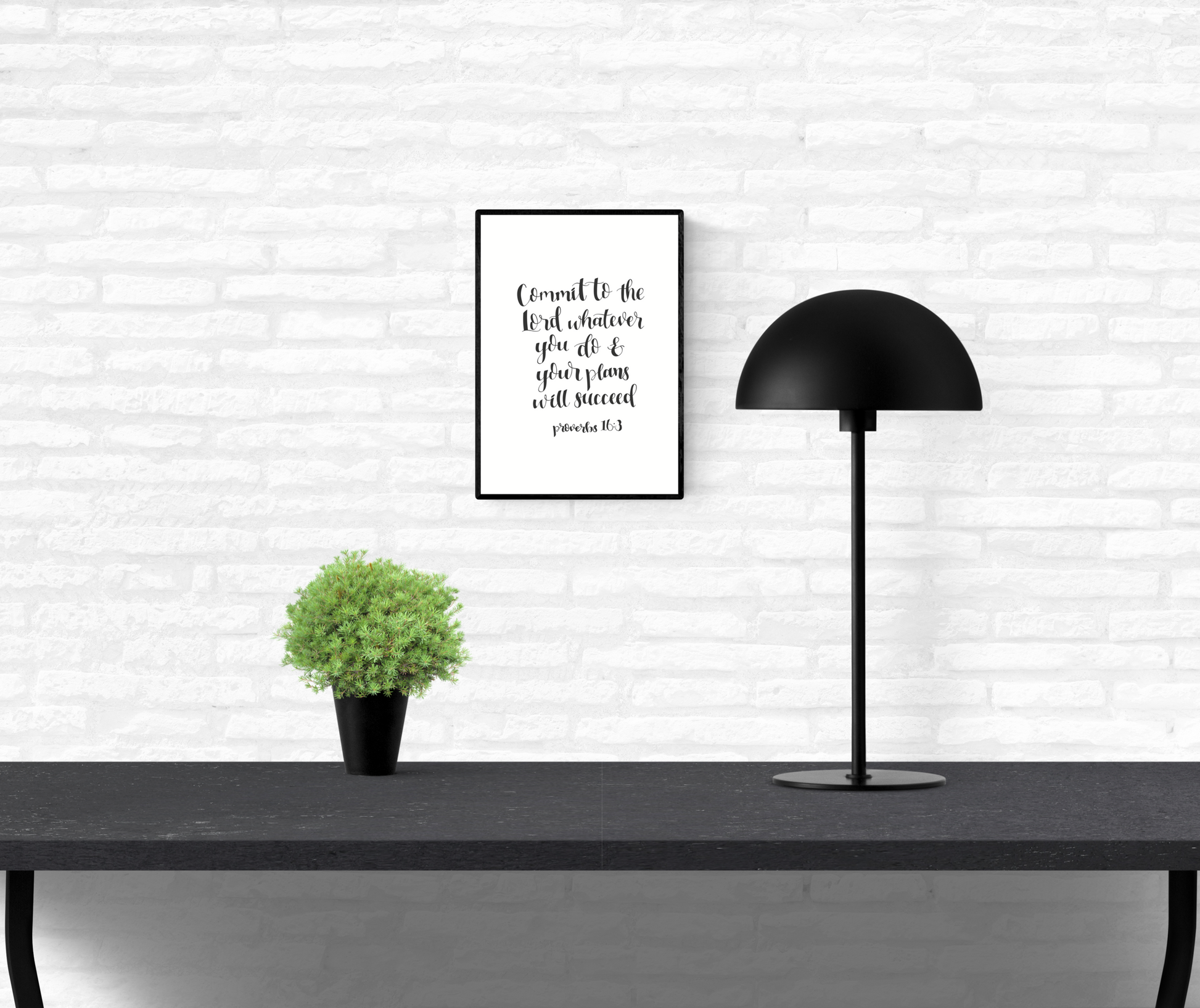 Quote wall print of Holy Bible scripture verse Proverbs 16:3 mounted on an interior white brick wall