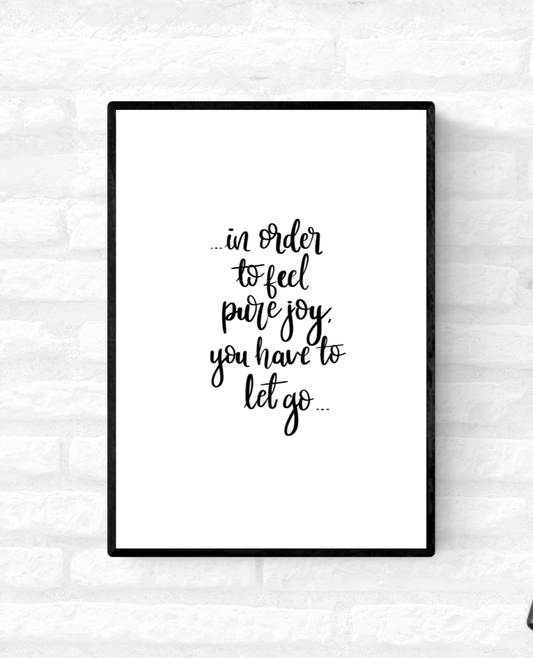 Framed wall quote print with the words, “in order to feel pure joy you have to let go” 