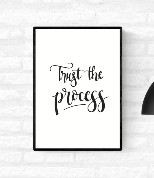 Framed wall quote print with the words “Trust the process”, in black and white colour